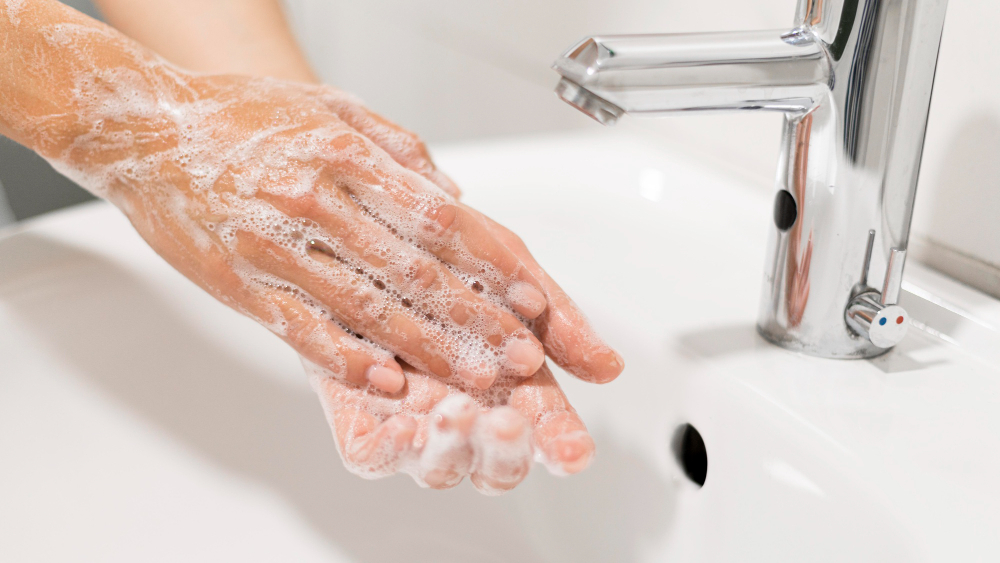 person washing hands with soap